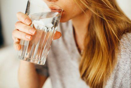 vrouw drinkt water in een glas 